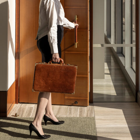 News Woman With Briefcase Opening Door