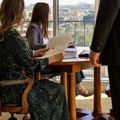 Two Women Man In Corner Office